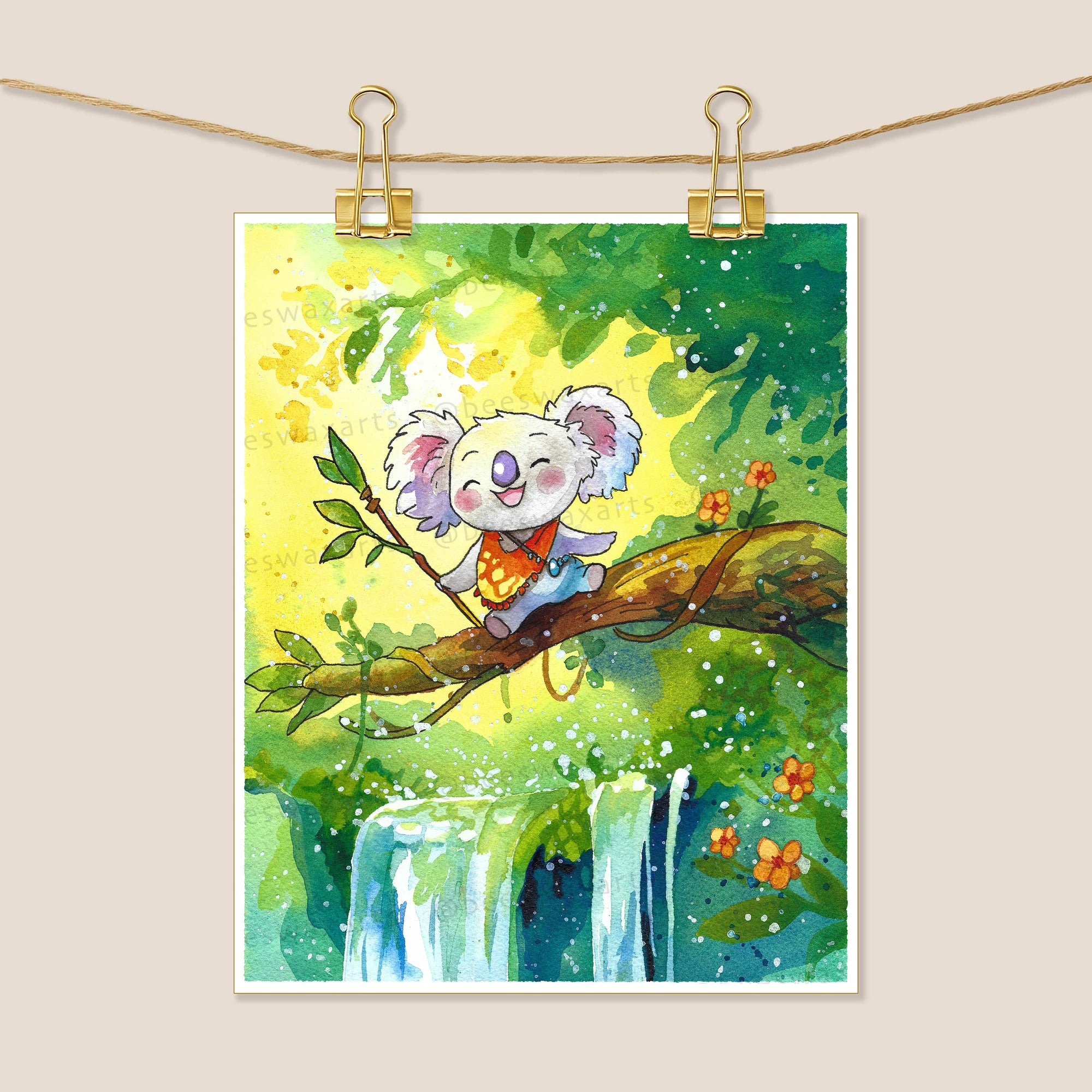 Waterfall Koala by Beeswax Arts Watercolors features a smiling koala in an orange vest perched above a waterfall, surrounded by foliage and red-orange flowers. Clipped with gold clips, this archival-quality print is ready to display.