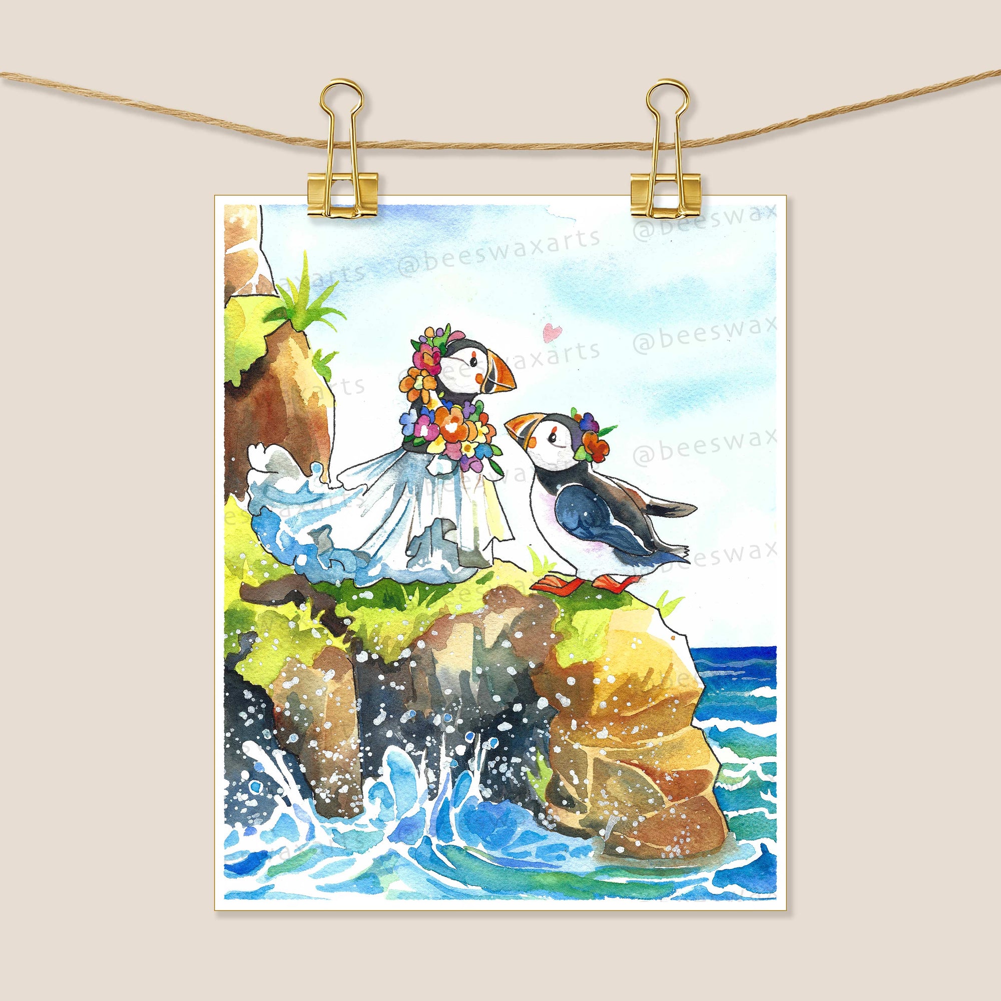 Puffin Wedding on Love Island by Beeswax Arts Watercolors—an 8x10 archival art print featuring two puffins, one in a veil and flower crown, the other with a bow tie, perched on a rocky seaside cliff above crashing waves.